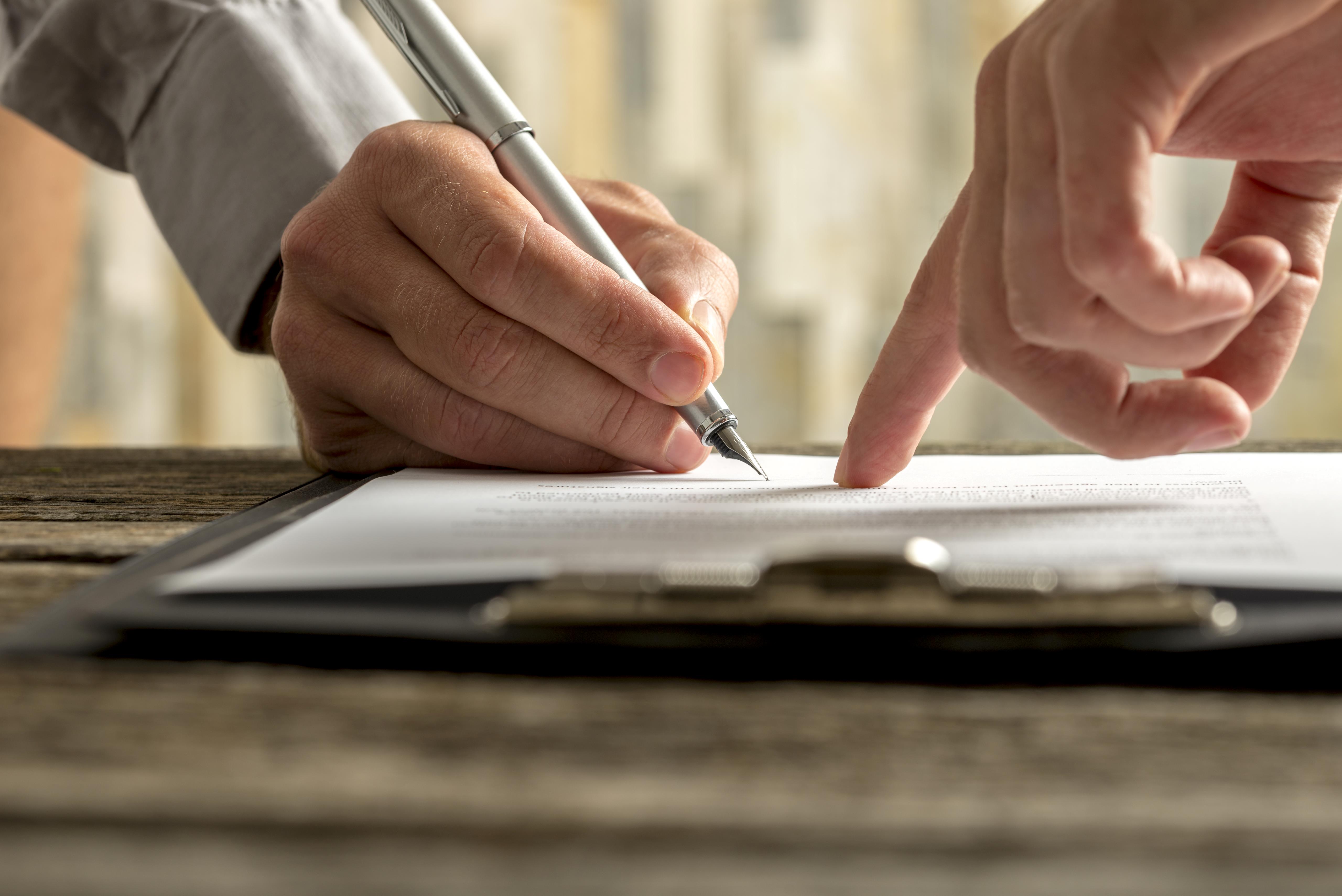 Man signing document